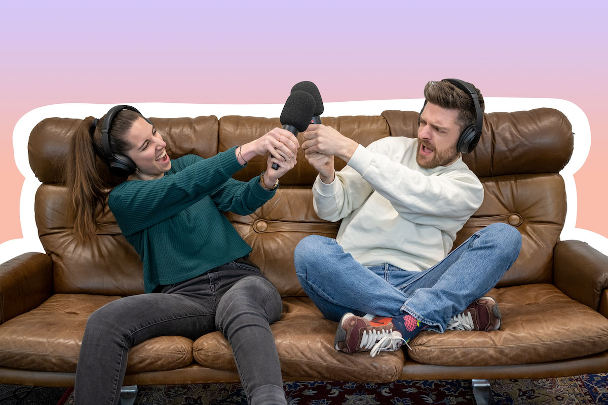 the two podcasters on a couch with microphones